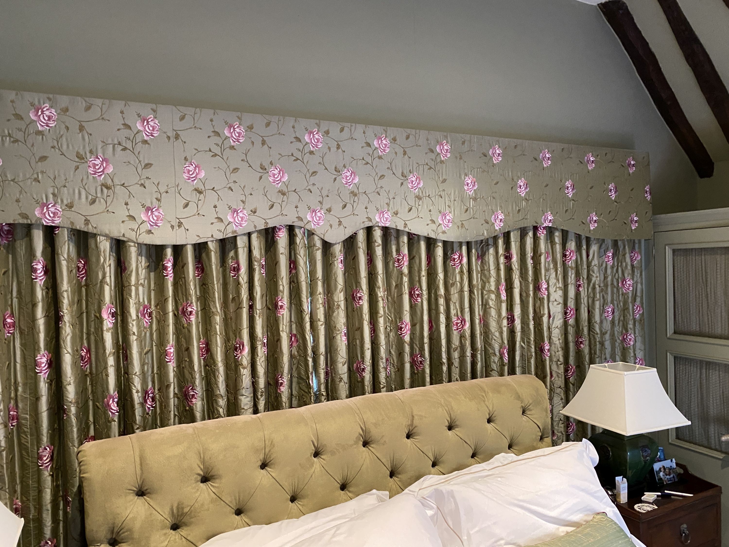 A pair of embroidered woven silk curtains, with pelmet, decorated with pink roses on a eau de nil ground, drop 2.3m, made to generously fit an aperture of 4m width